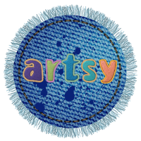 Frayed blue denim circular badge with dark blue paint splatter