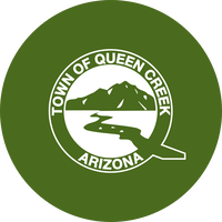 A green circle with a white Queen Creek Town logo on top