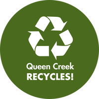 A green circle with a white recycling symbol on top. Under the symbol, it says "Queen Creek Recycles!"