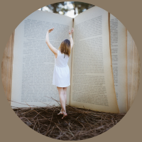 photograph of a woman standing in front of a book larger than her