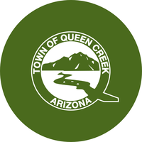 green circle with a white logo for Queen Creek on it.