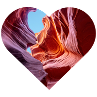 Heart shaped photo of a red rock slot canyon with a sliver of blue sky visible near the middle